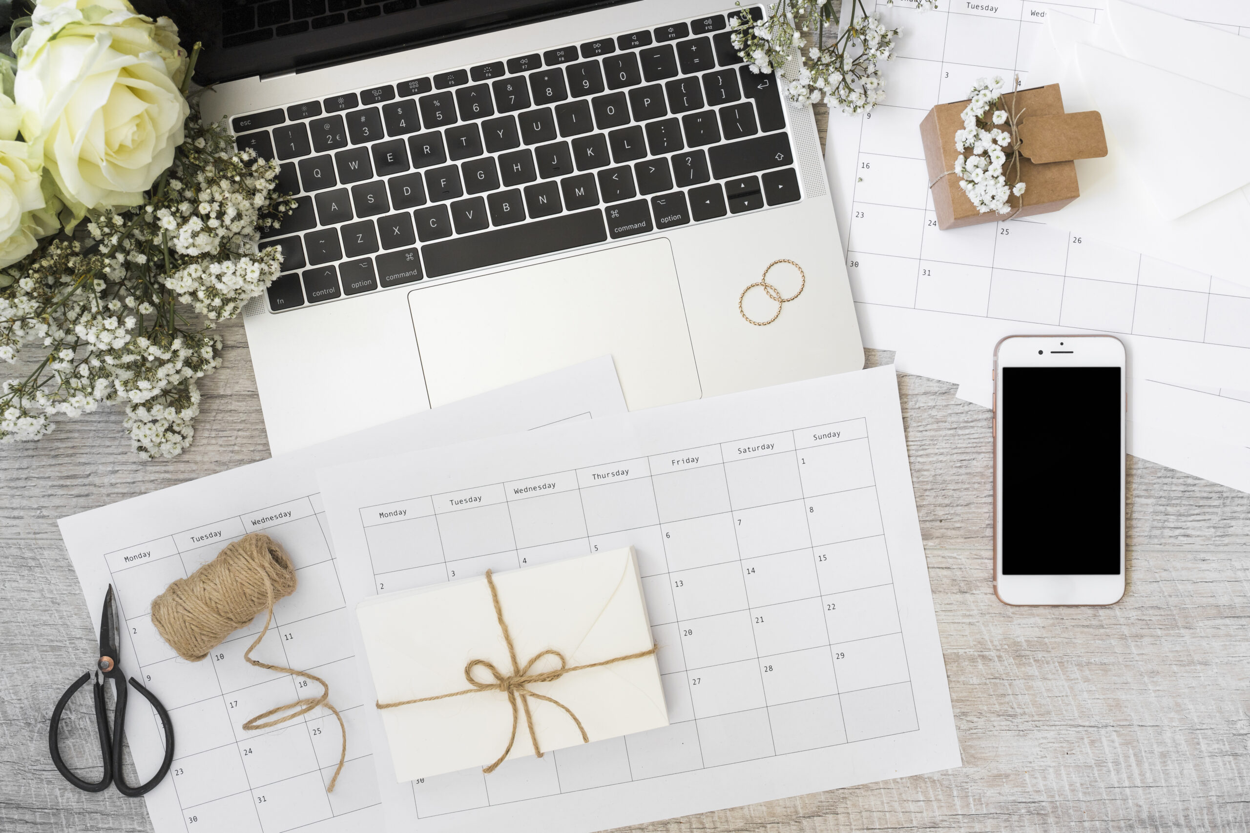 envelope-calendar-laptop-flowers-smart-phone-spool-scissor-spiral-notebook-wooden-desk